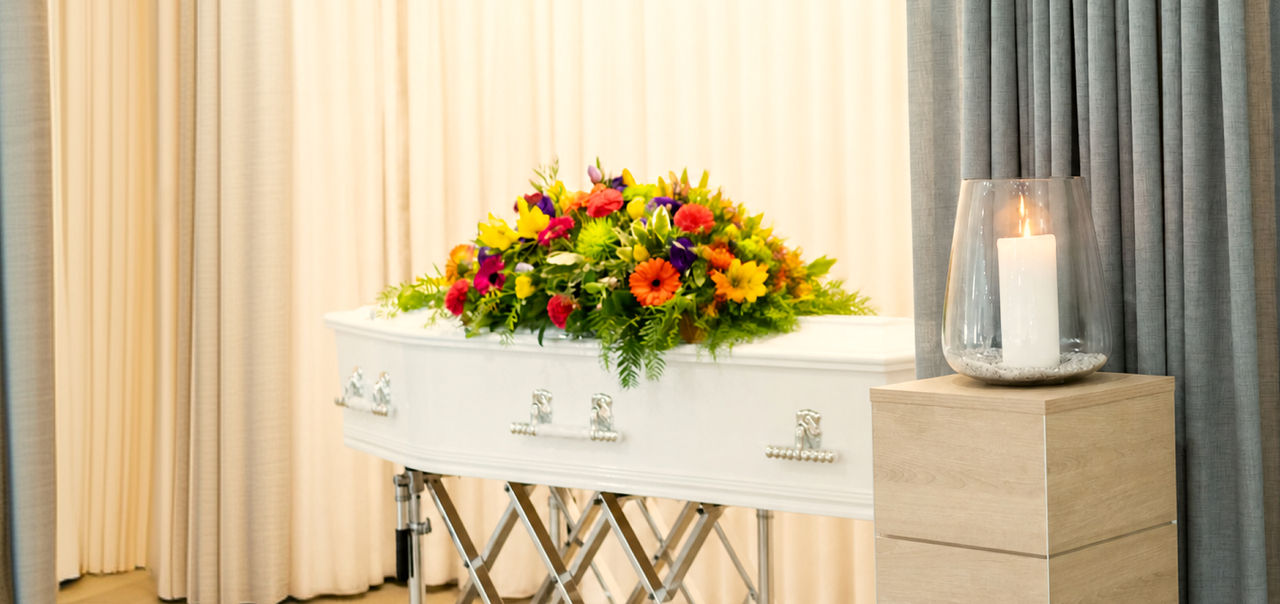 woman resting hand on coffin